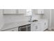 Close-up of stainless steel sink and white quartz countertops in a modern kitchen at 704 Georgia'S Landing Pkwy # 15, Raleigh, NC 27603