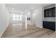 Spacious living room featuring hard surface flooring, natural light, and a modern wet bar at 704 Georgia'S Landing Pkwy # 15, Raleigh, NC 27603