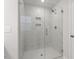 Modern shower with sleek glass door and white marble-look tile at 704 Georgia'S Landing Pkwy # 15, Raleigh, NC 27603
