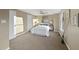 Well-lit bedroom featuring a full-size bed and a large window at 7306 Summerland Dr, Raleigh, NC 27612