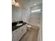 Well-lit bathroom with a shower and tub combination, modern vanity, and storage shelves at 93 Ausban Ridge Ln # 033, Four Oaks, NC 27524