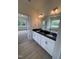 Bright bathroom featuring double vanity with granite counters and a separate tub, all with coordinated finishes at 93 Ausban Ridge Ln # 033, Four Oaks, NC 27524