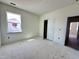 Bright, unfinished bedroom with a window, closet, and doorway, ready for personalization at 93 Ausban Ridge Ln # 033, Four Oaks, NC 27524