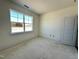 Bright bedroom with a window offering views of the outside, plus a closet with a solid door at 93 Ausban Ridge Ln # 033, Four Oaks, NC 27524