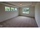 Spacious bedroom with carpet, natural light, and tray ceiling at 93 Ausban Ridge Ln # 033, Four Oaks, NC 27524