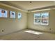 Bright bedroom with multiple windows overlooking the exterior of the home, and elegant crown molding at 93 Ausban Ridge Ln # 033, Four Oaks, NC 27524