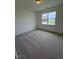 Carpeted bedroom featuring a large window offering abundant natural light at 93 Ausban Ridge Ln # 033, Four Oaks, NC 27524