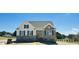Charming two-story home featuring brick accents, neutral siding, and manicured landscaping at 93 Ausban Ridge Ln # 033, Four Oaks, NC 27524