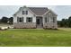 Charming home featuring brick and vinyl siding, inviting entryway, and a well-manicured lawn at 93 Ausban Ridge Ln # 033, Four Oaks, NC 27524