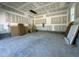 Spacious garage with unfinished walls, stairs to the upper floor and concrete flooring providing ample space at 93 Ausban Ridge Ln # 033, Four Oaks, NC 27524