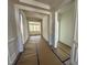 Bright hallway showcasing detailed trim work and moldings, leading to rooms with large windows at 93 Ausban Ridge Ln # 033, Four Oaks, NC 27524