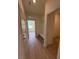 Hallway with wood-look flooring and a mudroom area with seating and storage, leading to another room at 93 Ausban Ridge Ln # 033, Four Oaks, NC 27524