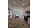 Modern kitchen featuring granite countertops, stainless steel appliances, and white cabinets at 93 Ausban Ridge Ln # 033, Four Oaks, NC 27524