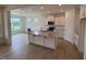 Modern kitchen featuring granite countertops, stainless steel appliances, and a large central island at 93 Ausban Ridge Ln # 033, Four Oaks, NC 27524
