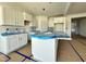 An elegant kitchen featuring white cabinets and a spacious island, offering ample storage and workspace at 93 Ausban Ridge Ln # 033, Four Oaks, NC 27524