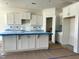 An elegant kitchen featuring white cabinets and a spacious island, offering ample storage and workspace at 93 Ausban Ridge Ln # 033, Four Oaks, NC 27524