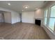 Bright living room with fireplace, recessed lighting, and large windows at 93 Ausban Ridge Ln # 033, Four Oaks, NC 27524
