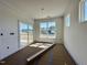 Bright living room with a sliding glass door to the outside porch and a large window overlooking the exterior of the home at 93 Ausban Ridge Ln # 033, Four Oaks, NC 27524