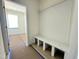 Bright mudroom with a white bench and storage compartments, leading to another room at 93 Ausban Ridge Ln # 033, Four Oaks, NC 27524