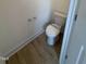 A half bathroom features a modern toilet and sleek laminate flooring at 93 Ausban Ridge Ln # 033, Four Oaks, NC 27524