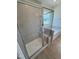Shower space with gray tile and glass doors next to soaking tub in the Primary bath at 93 Ausban Ridge Ln # 033, Four Oaks, NC 27524