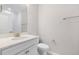 Modern bathroom featuring white vanity, quartz counters, toilet, and a walk-in shower at 102 Belmont Stakes Ln, Wendell, NC 27591