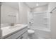 Modern bathroom with a white vanity, quartz counters, toilet, and shower-tub combo at 102 Belmont Stakes Ln, Wendell, NC 27591