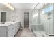 Luxurious bathroom with double vanities, a walk-in shower, and tile flooring at 102 Belmont Stakes Ln, Wendell, NC 27591