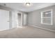 Bright bedroom featuring plush carpet, ample natural light, and closet access at 102 Belmont Stakes Ln, Wendell, NC 27591