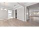 Open-concept dining room with wood floors, chandelier, and lots of natural light at 102 Belmont Stakes Ln, Wendell, NC 27591