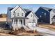 Charming two-story home featuring a well-manicured lawn, covered porch, and attached two-car garage at 102 Belmont Stakes Ln, Wendell, NC 27591