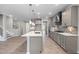 Modern kitchen featuring stainless steel appliances, a kitchen island, pendant lighting, and hardwood floors at 102 Belmont Stakes Ln, Wendell, NC 27591