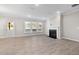 Bright living room featuring a fireplace, large windows, and hardwood floors at 102 Belmont Stakes Ln, Wendell, NC 27591