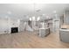 Spacious open-concept living area with a fireplace, hardwood floors, and seamless flow to the kitchen at 102 Belmont Stakes Ln, Wendell, NC 27591