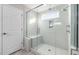 Modern bathroom showcasing a glass shower, white tile, and a convenient built-in seat at 102 Belmont Stakes Ln, Wendell, NC 27591