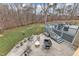 Aerial view of backyard featuring stamped concrete patio, deck, furniture, and lush greenery at 1126 Trailwood Dr, Raleigh, NC 27606