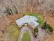 An aerial view showcases this property, highlighted by a circular driveway, a large yard, and mature trees at 1126 Trailwood Dr, Raleigh, NC 27606