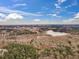 Aerial view showcases the property, highlighting the lake and city skyline visible from the tree-lined location at 1126 Trailwood Dr, Raleigh, NC 27606