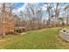 Large, level backyard with a custom observation deck and swing set, perfect for recreation and relaxation at 1126 Trailwood Dr, Raleigh, NC 27606