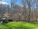 Large backyard with deck and wooded area beyond fence at 1126 Trailwood Dr, Raleigh, NC 27606