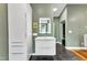 Modern bathroom showcasing sleek vanity with a lighted mirror and contemporary finishes at 1126 Trailwood Dr, Raleigh, NC 27606