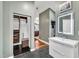 Bathroom featuring walk-in closet, sleek vanity with lighted mirror, and modern finishes at 1126 Trailwood Dr, Raleigh, NC 27606