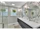 Stylish bathroom showcasing a dual vanity, modern fixtures, and attractive floral wallpaper at 1126 Trailwood Dr, Raleigh, NC 27606