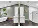 Modern bathroom featuring a double vanity, walk-in shower, stylish lighting, and tiled floors at 1126 Trailwood Dr, Raleigh, NC 27606