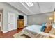 Bright bedroom with skylight, dresser, and hardwood floors at 1126 Trailwood Dr, Raleigh, NC 27606
