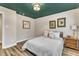 Bedroom featuring white walls, wood-look floors, and neutral decor at 1126 Trailwood Dr, Raleigh, NC 27606