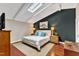 Cozy bedroom with skylight, white bed, and contrasting navy wall at 1126 Trailwood Dr, Raleigh, NC 27606
