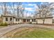 Ranch home with stone accents and a spacious front yard at 1126 Trailwood Dr, Raleigh, NC 27606