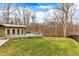 The home's rear features an elevated deck over a stamped concrete patio and a private, wooded backyard at 1126 Trailwood Dr, Raleigh, NC 27606