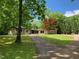 Ranch home with stone accents, large yard, and long driveway at 1126 Trailwood Dr, Raleigh, NC 27606